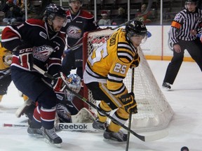 Jordan Kyrou of the Sarnia Sting and Saginaw Spirit captain Nick Moutrey battle for possession of the puck during OHL action at RBC Centre in Sarnia Friday night. The Sting defeated the Spirit 4-1. (TERRY BRIDGE, The Observer)
