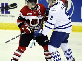 MISSISSAUGA , ON - DECEMBER 19: Michael McLeod #9 of the Mississauga Steelheads takes the face-off against Erik Bradford # 18 of the Ottawa 67's during OHL game action on December 19, 2014 at the Hershey Centre in Mississauga, Ontario, Canada.   Graig Abel/Getty Images/AFP== FOR NEWSPAPERS, INTERNET, TELCOS & TELEVISION USE ONLY ==