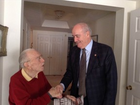WWII veteran Ernest Cote, 101, meets Veterans Affairs Minister Julian Fantino Friday. Cote was tied up and robbed a day earlier in his Ottawa home by a man who posed as a city employee. Fortunately, the D-Day veteran was not injured in the attack.