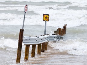 Part of a barricade sits under high waters at Ipperwash Beach on the shores of Lake St. Clair. CRAIG GLOVER The London Free Press / QMI AGENCY