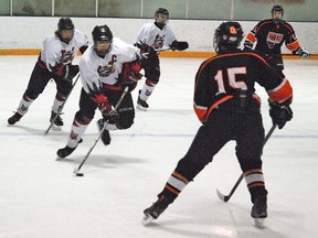 Vulcan midget Hawks captain Kyle Howe leads a charge into the Oyen Bees' zone Friday night at the Vulcan District Arena during first period action. Simon Ducatel Vulcan Advocate