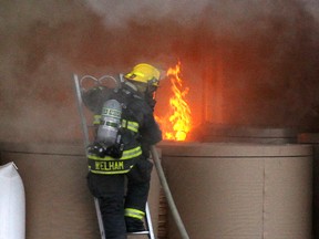 A Winnipeg firefighter battles a fire in a Burlington Northern boxcar near Westview Park in Winnipeg, Man. Wednesday June 04, 2014. There were no injuries reported.
Brian Donogh/Winnipeg Sun/QMI Agency