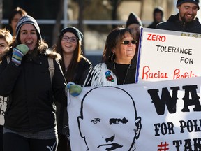 Demonstrators calling for the firing of Edmonton Police Service Sgt. Mike Wasylyshen march from Churchill Square to EPS headquarters in Edmonton, Alta., on Saturday, Dec. 20, 2014. Wasylyshen was suspended without pay for 120 hours in November, 2012 for using his Taser eight times on a 16-year-old boy more than a decade ago. He was promoted to sergeant in Dec. 2014. Ian Kucerak/Edmonton Sun/ QMI Agency