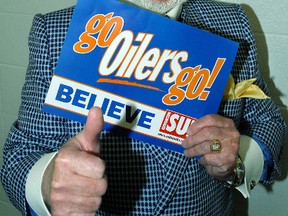 Don Cherry holds an Edmonton Sun "Go Oilers Go" sign before Game 4 of the Stanley Cup Final between the Oilers and Hurricanes at Rexall Place on June 12, 2006. (QMI Agency)