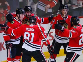 Chicago Blackhawks players celebrate a goal by left winger Brandon Saad (20) during their game against the Calgary Flames on Dec. 14, 2014, at United Center in Chicago. The Blackhawks entered play Saturday having won 10 of their past 11 games, and have jumped to the top spot in the current edition of Mike Zeisberger’s weekly NHL power rankings. Former No. 1 team Anaheim has slipped to No. 2 in the rankings, while Pittsburgh remained at No. 3. (KAMIL KRZACZYNSKI/USA Today Sports)