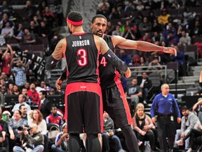 Patrick Patterson of the Raptors chest-bumps with teammate James Johnson during Friday night’s win over the Detroit Pistons at Auburn Hills, Mich. (AFP)