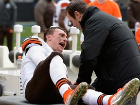 A trainer tends to Johnny Manziel #2 of the Cleveland Browns after he was injured during their game against the Carolina Panthers at Bank of America Stadium on December 21, 2014 in Charlotte, North Carolina.  (Grant Halverson/Getty Images/AFP)