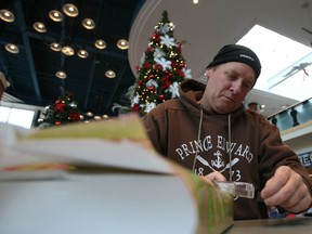 Volunteer gift-wrapper Gavin Lumsden says the busiest shopping weekend of the year was one which kept him hopping both with other people's gifts and his own. Ultimately, it was a weekend which gave him affirmation of the kindness of strangers.
DOUG HEMPSTEAD/Ottawa Sun/QMI AGENCY
