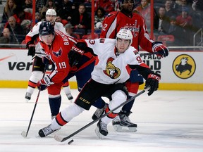 Mika Zibanejad #93 of the Ottawa Senators battles for the puck in the third period against Nicklas Backstrom #19 of the Washington Capitals at Verizon Center on January 21, 2014 in Washington, DC.  Greg Fiume/Getty Images/AFP