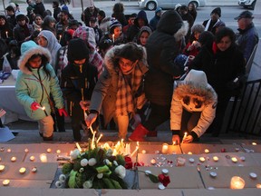 More than 100 parents, children and community members attend a candlelight vigil and solidarity gathering on the steps of City Hall in Kingston, Ont. on Saturday December 20, 2014. It is a show of support for the families of the 132 school children and nine staff at the school in Pakistan who were killed by terrorists on Dec. 16. Julia McKay/The Kingston Whig-Standard/QMI Agency
