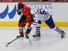 Chicago Blackhawks centre Jonathan Toews  battles for the puck with Toronto Maple Leafs defenceman Jake Gardiner on Dec. 21. (Kamil Krzaczynski-USA TODAY Sports)