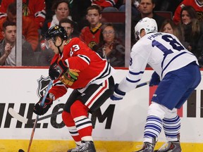 Chicago Blackhawks right wing Kris Versteeg (23) tries to keep the puck away from Toronto Maple Leafs right wing Richard Panik (18) during the first period of their NHL game at United Center. (KAMIL KRZACZYNSKI/USA TODAY Sports)