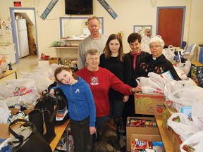 JOHN LAPPA/THE SUDBURY STAR
Britney Rollins, 9, left, Gert Riles, Graham Walker, Tayler Walker, Ann Murray and Rev. Genny Rollins prepare food hampers for 40 families for Christmas at the Coniston Food Bank located at All Saint Anglican Church in Coniston.