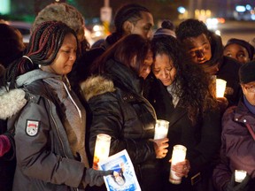 Crystal Diljohn, centre right, mother of 14-year-old Amaria Diljohn, attends a candlelight memorial last night at the corner of Neilson Rd. and Finch Ave. E., where her daughter died after being struck by a TTC bus on Friday. (Manny Rodrigues/Special to the Toronto Sun)