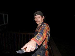 Riley Barrett holds one of his custom-made knifes. Barrett sources his own steel, cuts the blade profiles with a grinder and does the sanding and sharpening in his shed. John Stoesser photo/Pincher Creek Echo