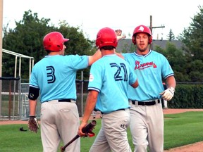The Sarnia Braves decided recently to switch to the Southwestern Senior Baseball League for the 2015 season. Pictured celebrating a Mike Damchuk home run last season are, from left, centre fielder James Grant, left fielder Alex McLean and first baseman Damchuk. (Submitted photo)
