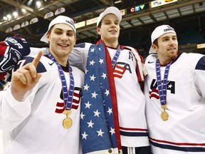 Team USA's Ryan Bourque (L), John Carlson (C) and David Warsofsky are seen with their gold medals after they defeated Canada to win the gold medal game in overtime at the 2010 IIHF U20 World Junior Hockey Championship in Saskatoon, Sask. January 5, 2010. (REUTERS)