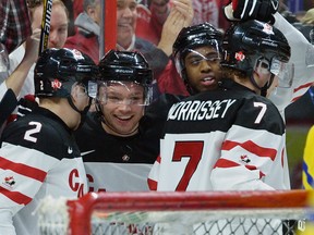 Team Canada players celebrate a goal during first period pre-tournament IIHF hockey at the Canadian Tire Centre in Ottawa on Sunday, Dec. 21, 2014. (Matthew Usherwood/QMI Agency)