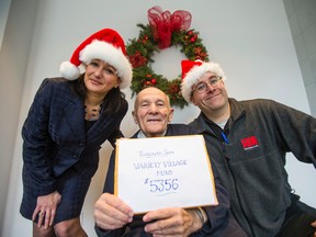 Mort Greenberg presents money raised for the Variety Village Christmas Fund to Toronto Sun's Christina Fleming and Iain Skinner. (ERNEST DOROSZUK, Toronto Sun)