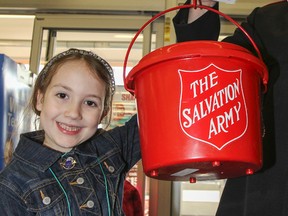 Six-year-old Abigail Howard volunteers with her father, Josh Howard, at one of the kettles at the Walmart Superstore in the final days of the Salvation Army Christmas Kettles campaign on Monday December 22, 2014 in Kingston, Ont. Julia McKay/The Kingston Whig-Standard/QMI Agency