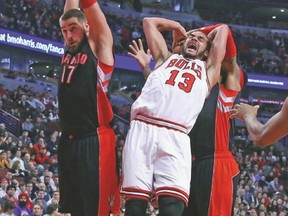 Chicago Bulls centre Joakim Noah is fouled by Toronto Raptors forward James Johnson (right) during Monday night’s game. (USA TODAY SPORTS)