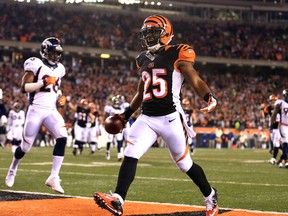 Bengals running back Giovani Bernard (right) celebrates after scoring a touchdown during third quarter NFL action against the Broncos in Cincinnati on Monday, Dec. 22, 2014. (Andrew Weber/USA TODAY Sports)