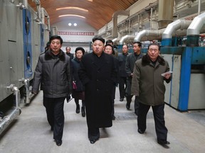 North Korean leader Kim Jong-un (front C) gives field guidance at the Kim Jong Suk Pyongyang Textile Mill in this undated photo released by North Korea's Korean Central News Agency (KCNA) in Pyongyang Dec. 20, 2014.   REUTERS/KCNA