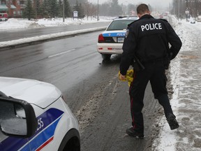 Ottawa Police investigate after an OC Transpo bus struck a man on Tuesday along Montreal Rd. at Carsons Rd., causing severe leg fractures. (OTTAWA SUN Doug Hempstead)