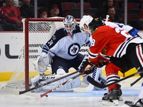 Winnipeg Jets goalie Michael Hutchinson makes a save against Chicago Blackhawks right winger Ben Smith last month. Hutchinson and the Jets play the Hawks on Tuesday night. (Mike DiNovo-USA TODAY Sports file photo)