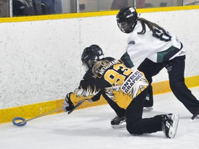 Erika Neubrand (93) of the Mitchell U14AA ringette team battles for the ring along the end boards against visiting London Dec. 18. The Stingers lost, 4-1. ANDY BADER/MITCHELL ADVOCATE