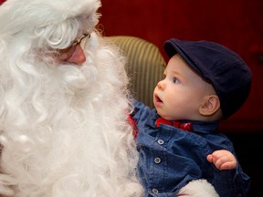 Jack Lalonde looks up at Santa at the annual Bundles of Joy party held at the London District Catholic school board's head office. Mike Hensen/The London Free Press/QMI Agency