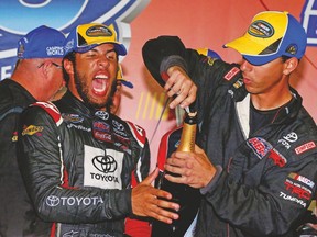 Darrell (Bubba) Wallace Jr. (left) celebrates after winning a NASCAR Camping World Truck Series race last season. (AFP)