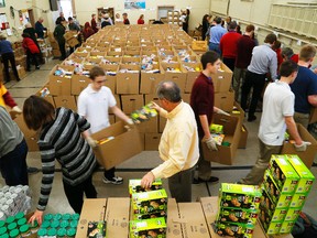 A steady stream of volunteers load 800 boxes in an assembly line manner at the Salvation Army in Peterborough on Wednesday, Dec. 17, 2014. (Clifford Skarstedt/QMI Agency)