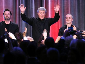 Prime Minister Stephen Harper waves to the audience after performing with the band the Van Cats during the Conservative caucus Christmas party in Ottawa earlier this month. (REUTERS)
