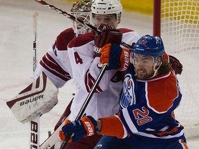 Oilers forward Luke Gazdic battles with Coyotes defenceman Zbynek Michalek during first-period action Tuesday at Rexall Place. (David Bloom, Edmonton Sun)