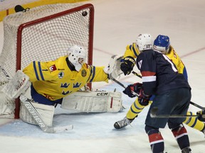Team USA forward Alex Tuch flicks the puck into the top corner past Swedish goaltender Samuel Ward during the second period of a world junior hockey exhibition game at the Rogers K-Rock Centre on Tuesday night.  Tuch scored three goals in Team USA’s 10-5 win. (Elliot Ferguson/The Whg-Standard)