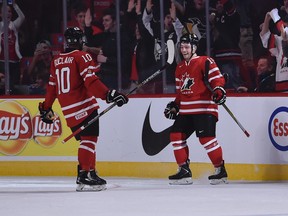 Canada's Anthony Duclair (left) comes to congratulate teammate Max Domi (right) after a goal against Switzerland in the second period of a world junior tournament exhibition game in Montreal on Dec. 23,  2014. 
(Michel Desbiens/QMI Agency)