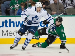 Maple Leafs centre Mike Santorelli skates past a fallen Dallas Star during Tuesday night’s game in Texas. (USA TODAY SPORTS)