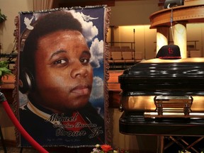 A baseball cap and a portrait of Michael Brown is shown alongside his casket inside Friendly Temple Missionary Baptist Church before the start of funeral services in St. Louis, Mo., Aug. 25, 2014. REUTERS/Robert Cohen/Pool