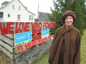 Sandra de Jong stands next to signs she set up outside her home in the Sunset Acres community of Plympton-Wyoming, to show her support for wind energy. She and her husband, Dean, have presenter status at an Ontario Environmental Review Tribunal holding hearings into an appeal of Suncor's plans to build a wind project in Lambton County. The de Jongs support the project. (PAUL MORDEN/THE OBSERVER/ QMI AGENCY)