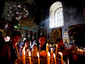 Visitors light candles in the Church of the Nativity, the site revered by Christians as Jesus' birthplace, ahead of Christmas in the West Bank town of Bethlehem. Many Christians consider Advent an essential time of preparation and spiritual cleansing ahead of Christmas (REUTERS PHOTO).