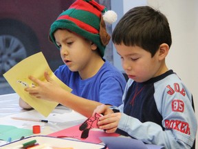 Brothers Lucas, 7, left, and Mathias Chapman, 5, make pop-up books during a recent holiday party at the Judith and Norman Alix Art Gallery. It's one of several seasonally inspired art activities the downtown gallery has been hosting this month. TYLER KULA/ THE OBSERVER/ QMI AGENCY