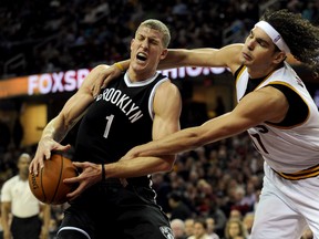Cleveland Cavaliers centre Anderson Varejao (right) fouls Brooklyn Nets centre Mason Plumlee (1) during the first quarter at Quicken Loans Arena. (Ken Blaze/USA TODAY Sports)