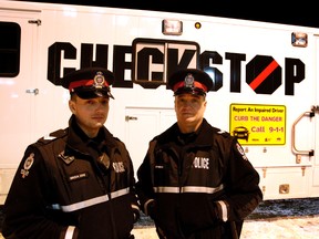 Edmonton Police Service's Impaired Driving Control Measures Unit members David Green (left) and Sgt. Conrad Moschansky stand in front of the EPS Checkstop "Bus". Tom Braid/Edmonton Sun/QMI Agency