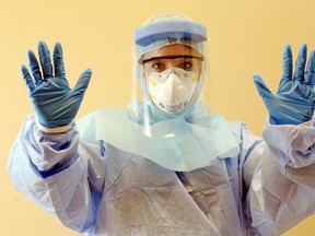 Emergency registered nurse Laura Moores wears personal protective equipment for treating patients with such infectious diseases as Ebola virus at Belleville General Hospital in Belleville, Ont., Thursday, Oct. 30, 2014. (Luke Hendry//QMI Agency)