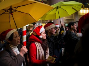 Pro-democracy protesters, holding up yellow umbrellas, a symbol of the Occupy Central civil disobedience movement, attend a protest at Times Square in Hong Kong early December 25, 2014. (REUTERS/Tyrone Siu)