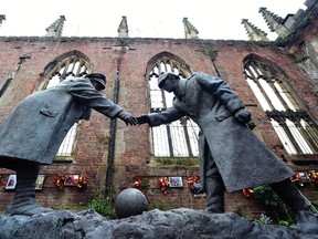 A resin model of a sculpture illustrating the First World War Christmas Truce football match is pictured during a photocall inside the remains of St Luke's Church in Liverpool, north west England, on Dec. 15, 2014. The model, by artist Andrew Edwards, shows two soldiers, one British, the other German, greeting each other, and will be cast in bronze once funds have been raised for its completion. AFP PHOTO/PAUL ELLIS