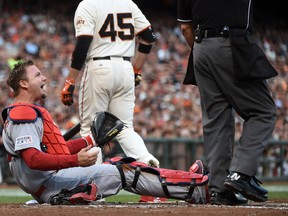 St. Louis Cardinals catcher A.J. Pierzynski (12) reacts after being hit by the bat of San Francisco Giants first baseman Travis Ishikawa (45) during the second inning in game four of the 2014 NLCS playoff baseball game at AT&T Park on Oct 15, 2014 in San Francisco, CA, USA. (Kyle Terada/USA TODAY Sports)