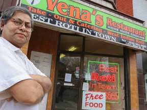 Mashud Siddique, 72, owner of Vena's Restaurant on Bloor St. W., serves up free meals on Christmas Day in Toronto Thursday December 25, 2014. (Dave Thomas/Toronto Sun)
