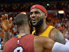 Cavaliers forward LeBron James (right) hugs Heat guard Dwyane Wade after their game in Miami on Thursday, Dec. 25, 2014. (Steve Mitchell/USA TODAY Sports)